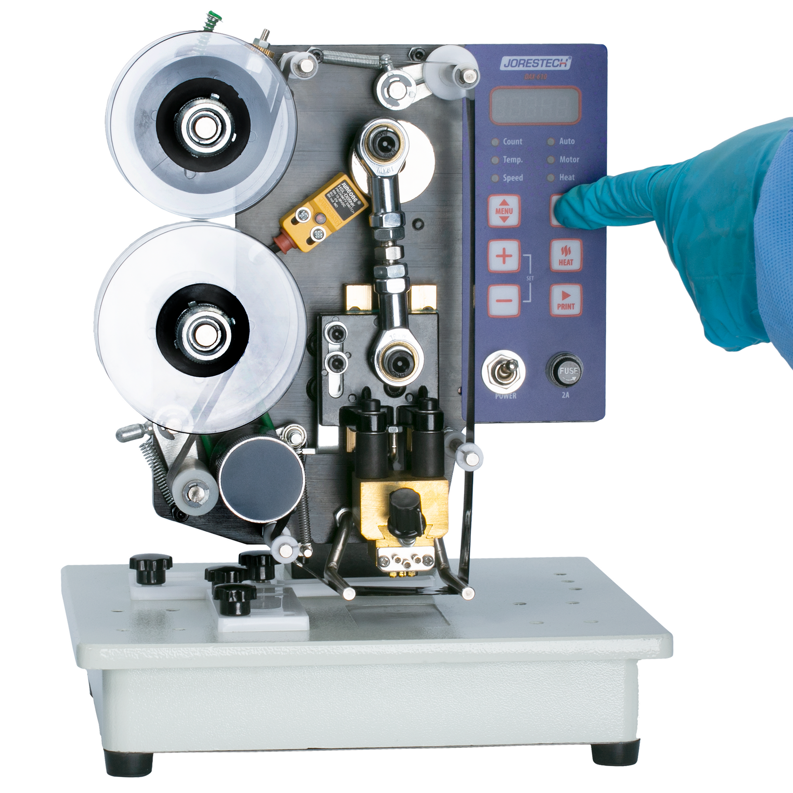 A person wearing protective gloves pressing the on/off button of the JORESTECH semi-automatic digital hot foil stamping printer