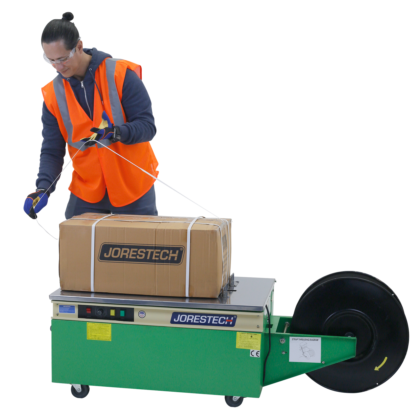 Man using the JORESTECH® low profile poly strapping machine to secure and package a box for shipping