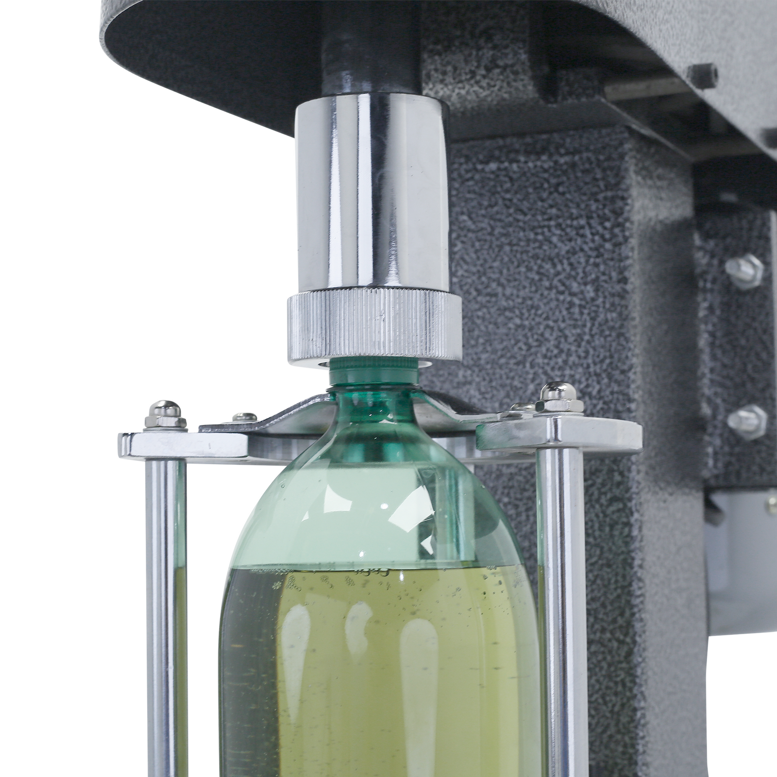 close up of JORES TECHNOLOGIES® semi-automatic gray bottle capper with green plastic bottle filled with green liquid inserted. The capper is screwing the cap in the green bottle.