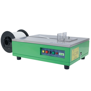 Front of a green JORESTECH® semi automatic poly strapping machine with a white mounted roll of strapping bands