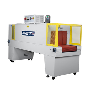 Diagonal view of a JORESTECH Shrink wrapping heat tunnel machine over white background.  Showing the entry conveyor, the insulation curtain, the control panel and one of the fan motors of the shrink tunnel.