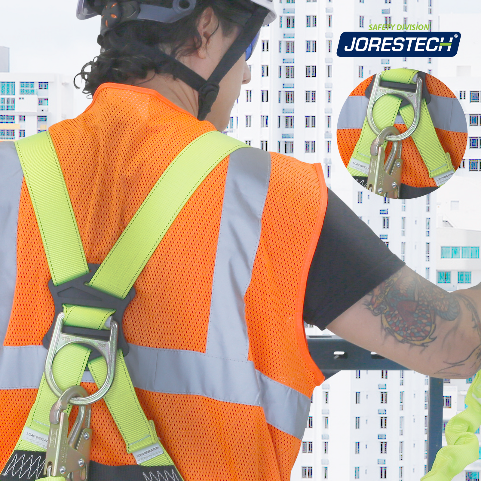 A man wearing a harness with a Jorestech single leg internal shock absorbing lanyard with snap hook and scaffolding hooked to one of the D rings of the harness. The man is standing in a scaffold at a high altitude