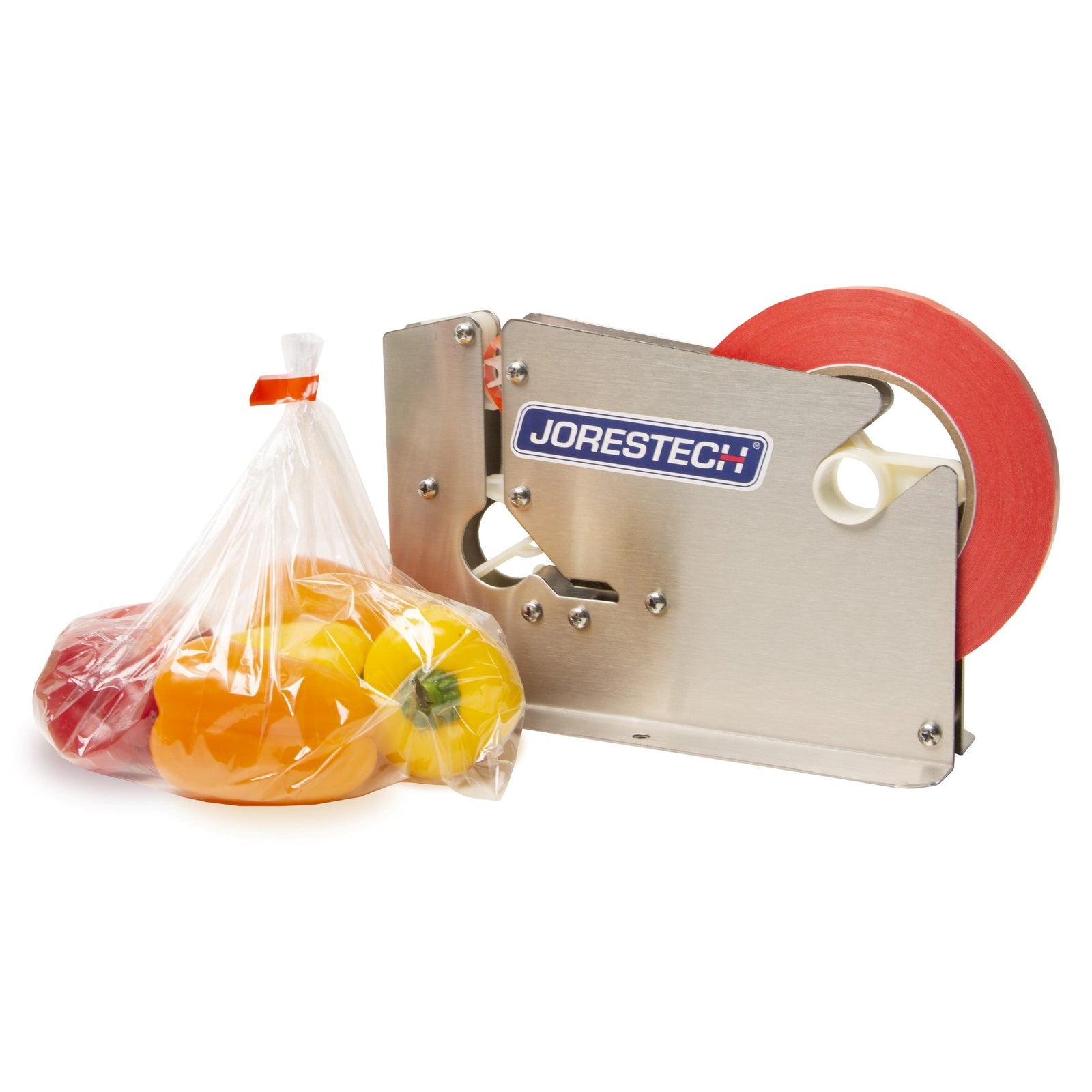 A stainless steel manual bag taper with red tape roll, next to a taped plastic bag filled with red, orange, and yellow bell peppers.