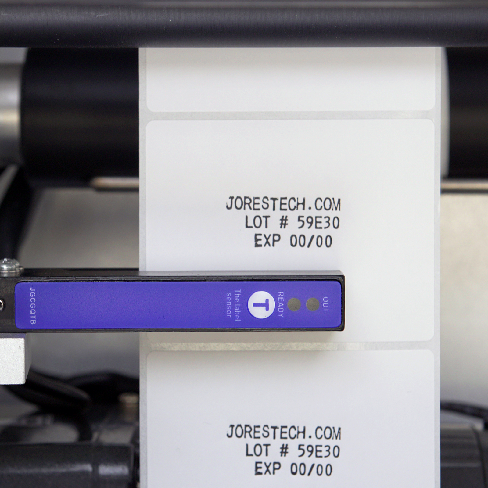close up of sensor and printed label with brand name, lot number and date of production on a Semi Automatic Label applicator with integrated printer