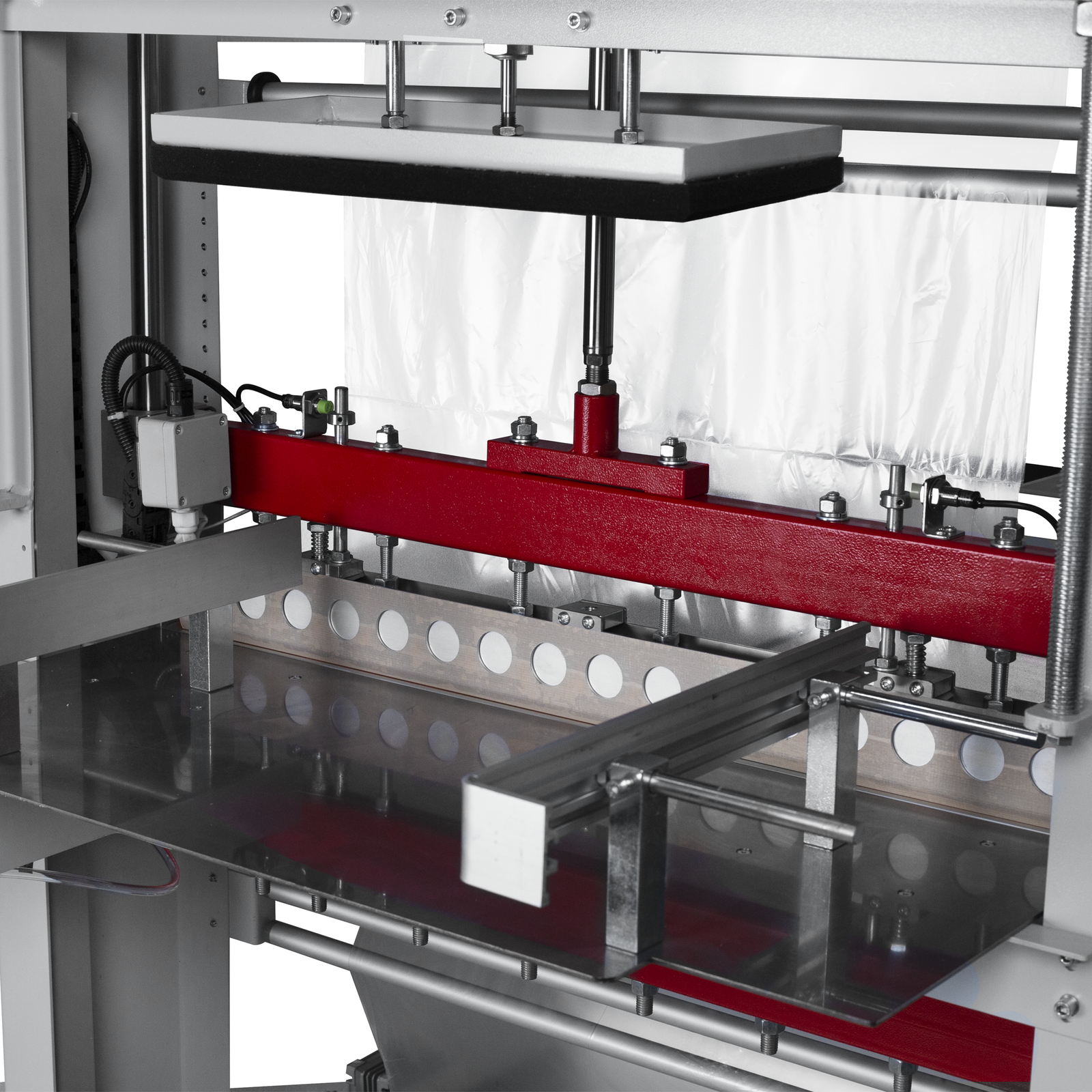 Close-up of the sealing bar and cutting blade of the sleeve film sealer