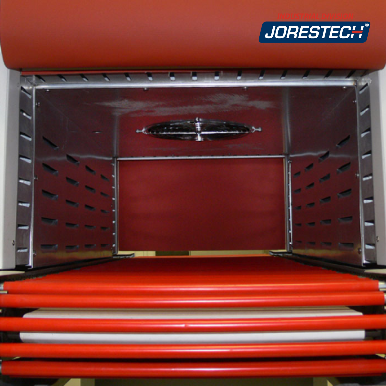 Interior of the tunnel showing the chamber, the heating fan, the roller conveyor and the exit curtain of the machine.