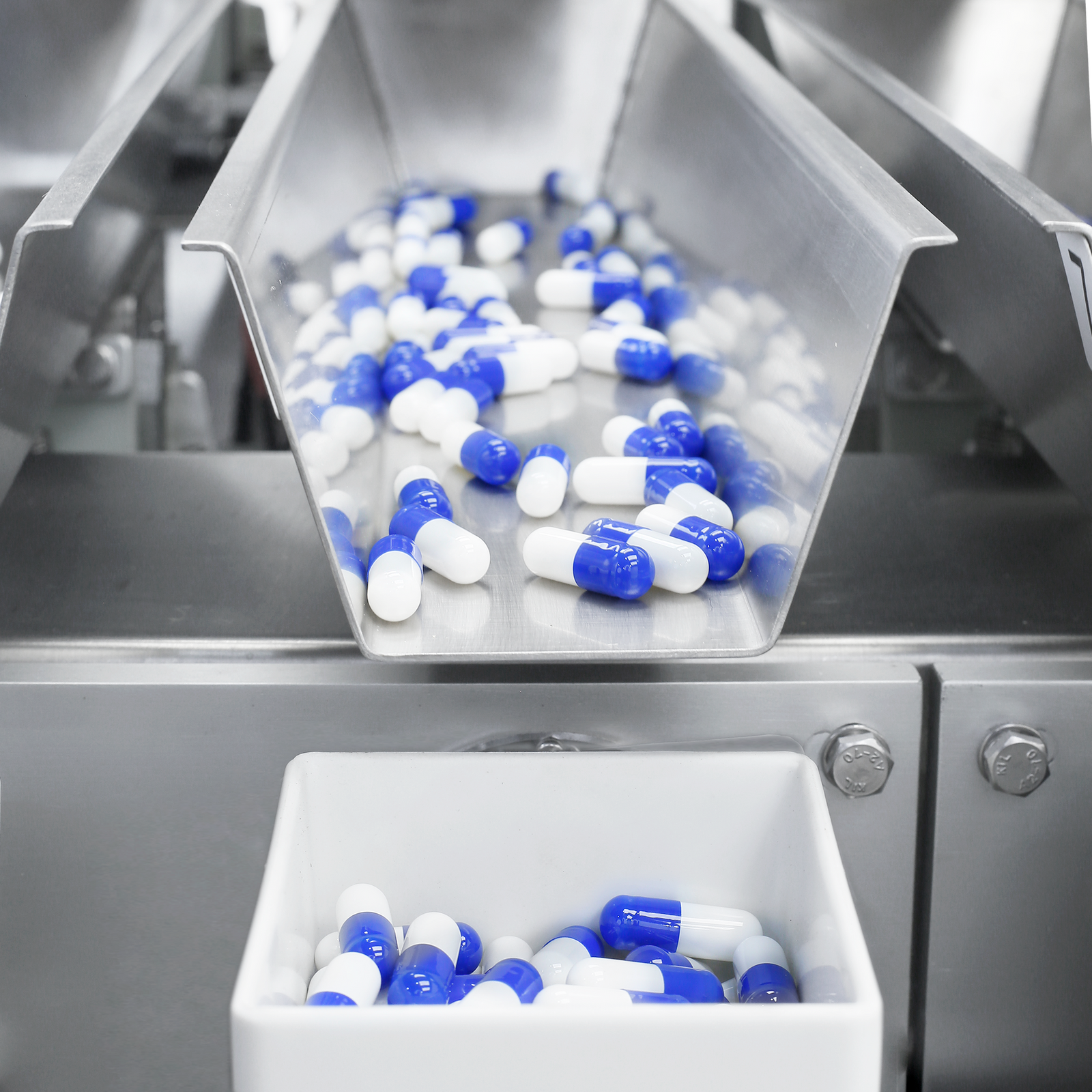 Close-up of a JORES TECHNOLOGIES® four head linear weigher measuring and dispensing capsules