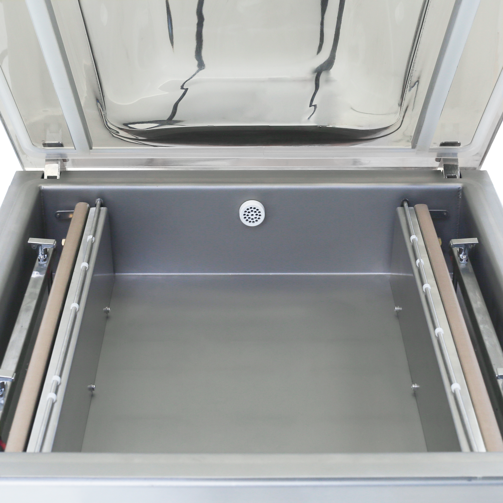 the stainless steel commercial single chamber vacuum sealer with two 20 inch sealing bars. 2 sealing elements,  4 gas flush connectors and the round vacuum vent are on the inside of the vacuum chamber.