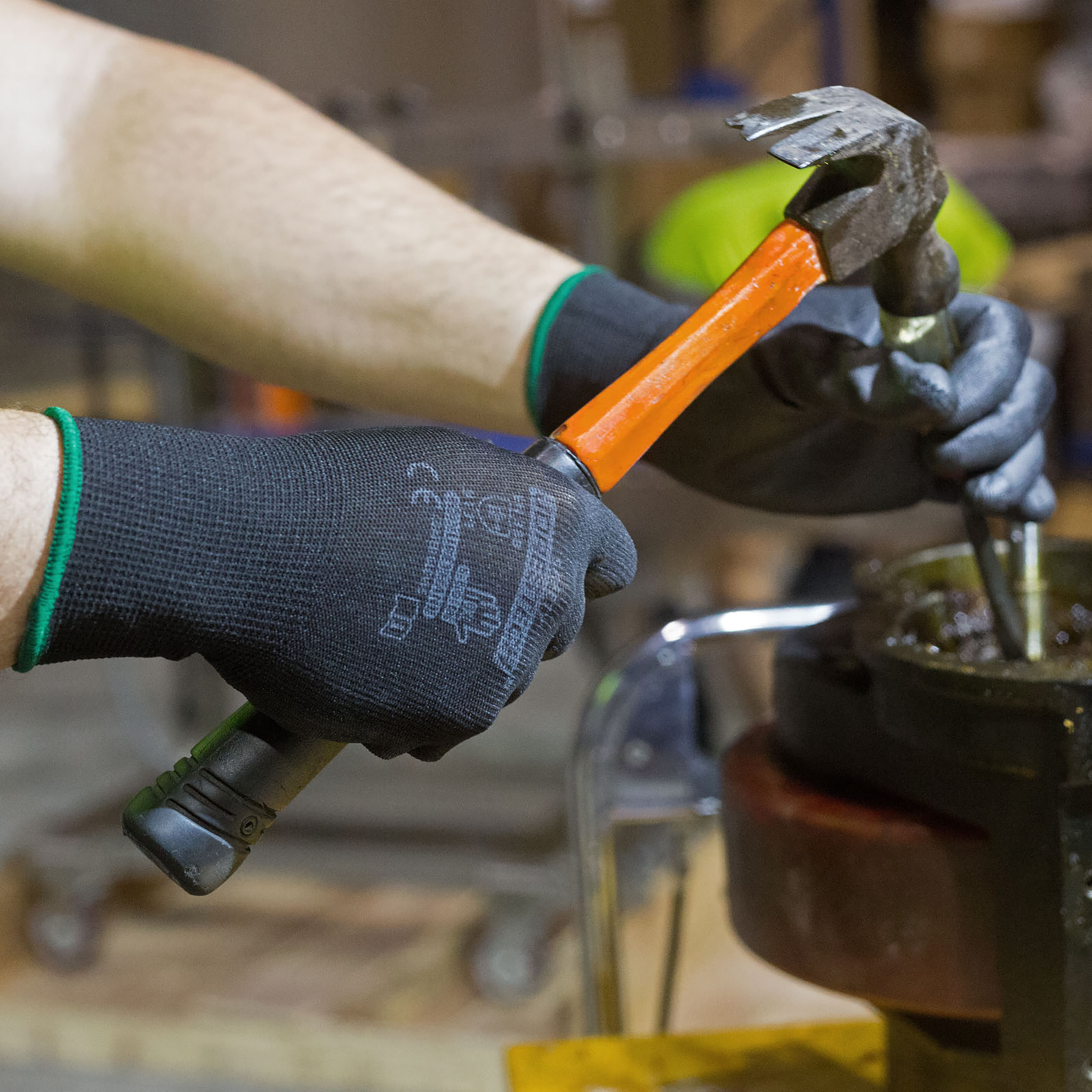 worker doing mechanics while wearing the black thin safety work glove with polyurethane dipped palms