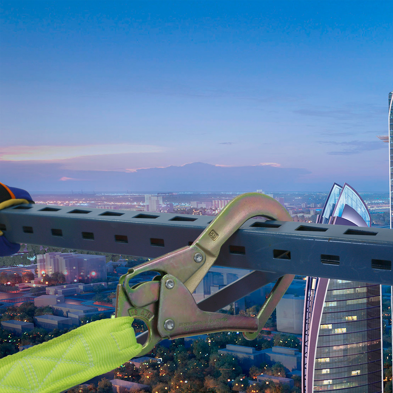 Close up shows one of the snap hooks of the JORESTECH twin leg internal shock absorbing lanyard attached to a scaffold located in a very high building structure. 
