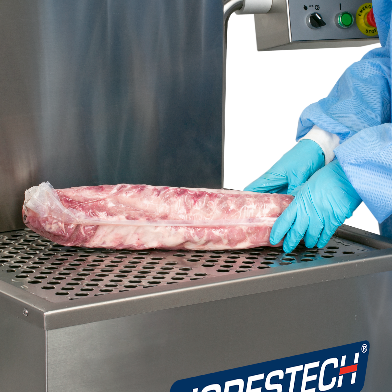 Hands of a person wearing disposable protective clothing removing a rack of ribs with shrink film vacuumed from the water tank of a JORES TECHNOLOGIES® semi-automatic dip style hot water shrink machine